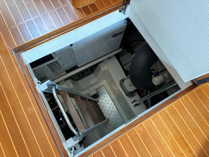 Hezitation Yacht Photos Pics Engine room access hatch on 2009 Grand Banks 45 Eastbay SX yacht with wooden flooring.