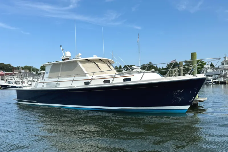 Hezitation Yacht Photos Pics 2009 Grand Banks 45 Eastbay SX yacht on calm water, under clear blue sky.