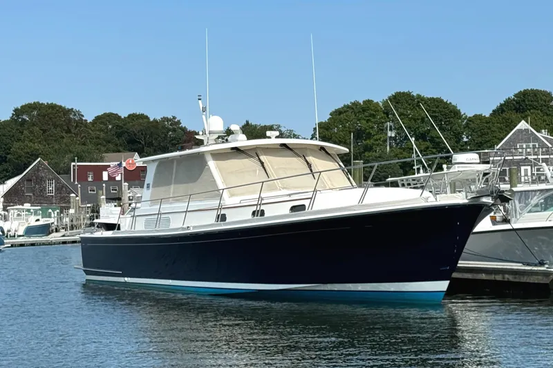 Hezitation Yacht Photos Pics 2009 Grand Banks 45 Eastbay SX yacht docked in a marina, surrounded by other boats.