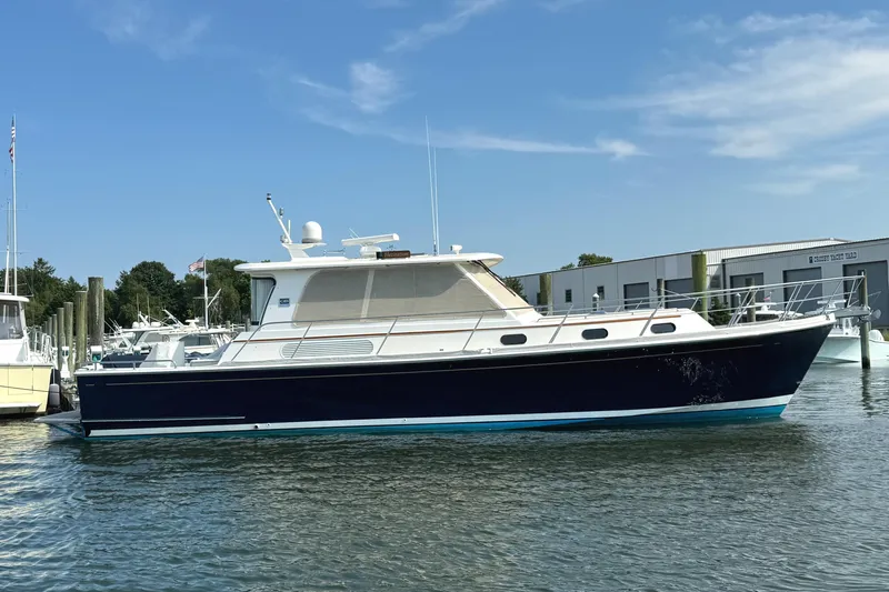 Hezitation Yacht Photos Pics 2009 Grand Banks 45 Eastbay SX yacht docked in marina under clear blue sky.