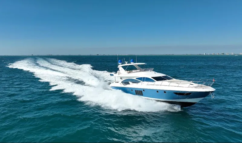 Emma Yacht Photos Pics Luxury 2014 Azimut 70 yacht cruising on open sea under clear blue sky.