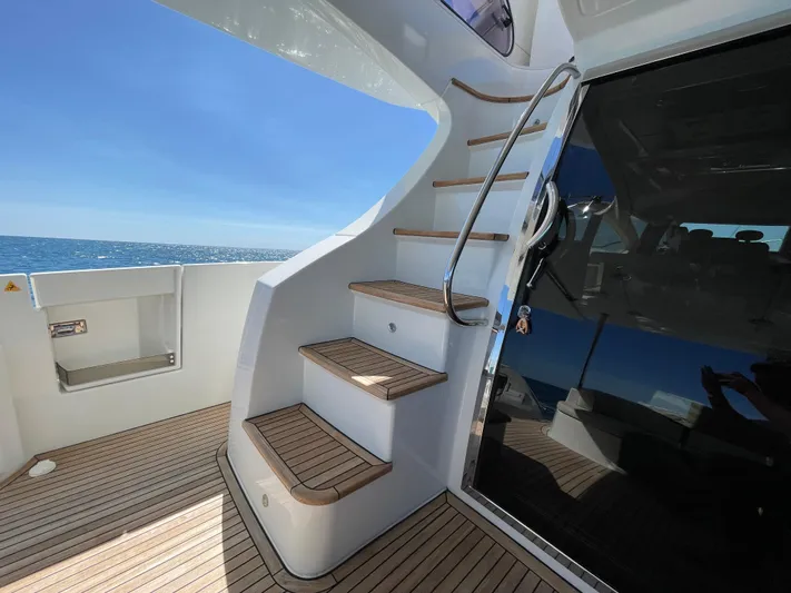 Emma Yacht Photos Pics Staircase on 2014 Azimut 70 yacht with ocean view and wooden deck.