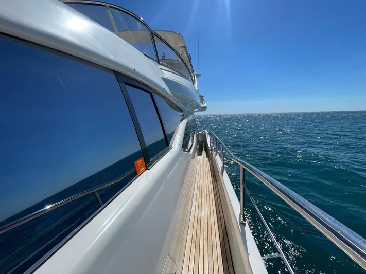 Emma Yacht Photos Pics 2014 Azimut 70 yacht cruising on open sea under clear blue sky.