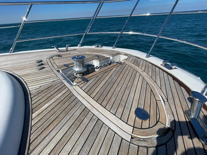 Emma Yacht Photos Pics 2014 Azimut 70 yacht deck with wooden finish, cruising on open water.