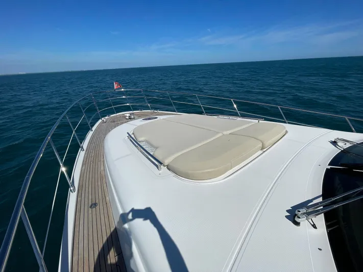 Emma Yacht Photos Pics 2014 Azimut 70 yacht deck with sunbed, cruising on open sea under clear blue sky.