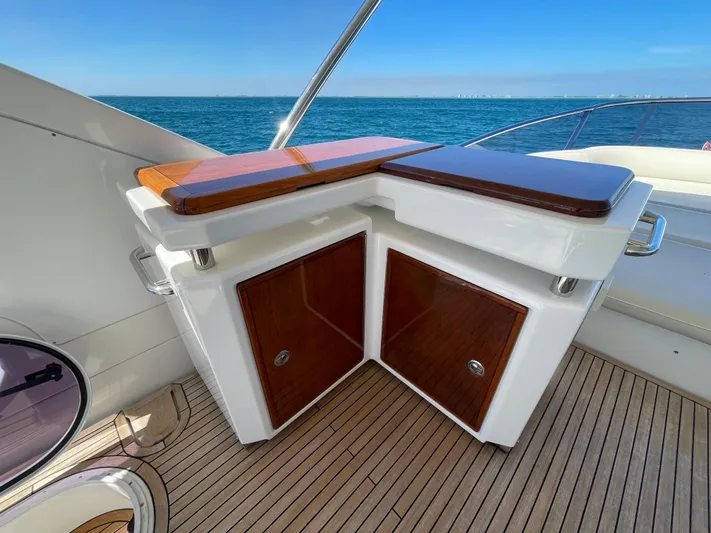 Emma Yacht Photos Pics Luxurious 2014 Azimut 70 yacht deck with elegant wood cabinetry and ocean view.