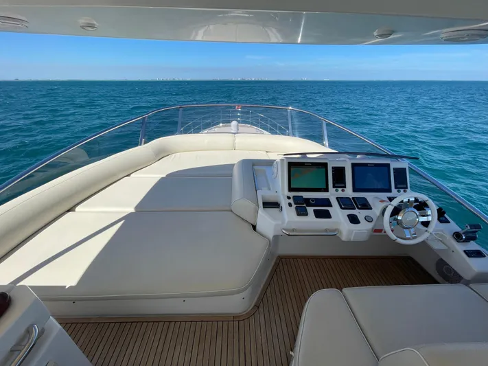 Emma Yacht Photos Pics 2014 Azimut 70 yacht helm with ocean view, featuring modern navigation equipment and luxurious seating.