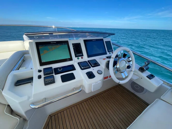 Emma Yacht Photos Pics 2014 Azimut 70 yacht helm with navigation screens and steering wheel, overlooking the ocean.