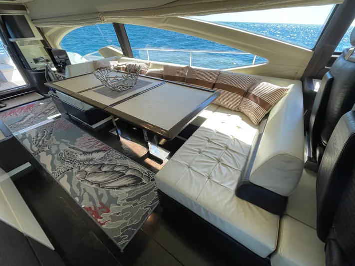 Emma Yacht Photos Pics Luxurious interior of a 2014 Azimut 70 yacht with elegant seating and ocean view.