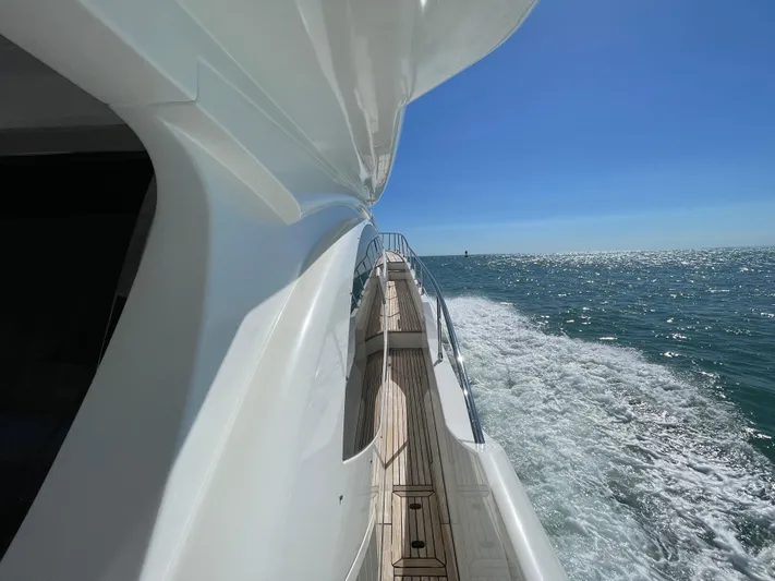 Emma Yacht Photos Pics Azimut 70 yacht cruising on open water, 2014 model, sunny day, ocean view.