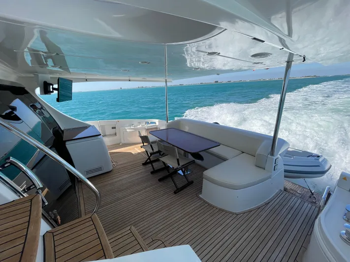 Emma Yacht Photos Pics Luxurious 2014 Azimut 70 yacht cruising on open sea with elegant deck seating.