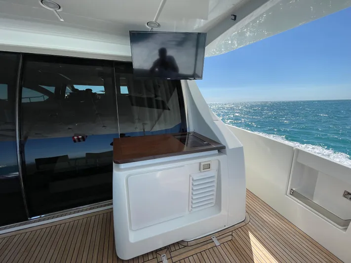 Emma Yacht Photos Pics Azimut 70 yacht deck with TV, ocean view, and sleek design, 2014 model.