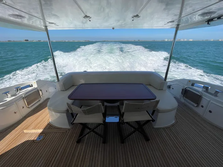 Emma Yacht Photos Pics Azimut 70 yacht deck with table, chairs, and ocean view, 2014 model.