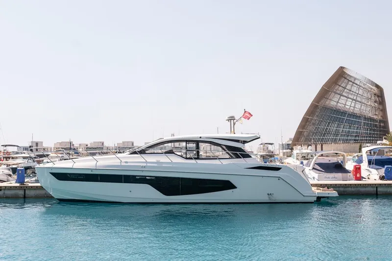 Rogue 33 Yacht Photos Pics 2019 Azimut Atlantis 51 yacht docked in a marina with modern architecture.