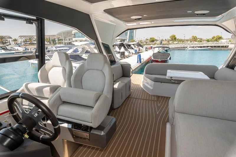 Rogue 33 Yacht Photos Pics Luxurious interior of 2019 Azimut Atlantis 51 yacht at marina, featuring plush seating and modern design.