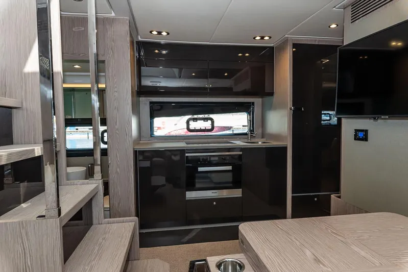 Rogue 33 Yacht Photos Pics Luxurious interior of 2019 Azimut Atlantis 51 yacht, featuring modern kitchen and sleek design.