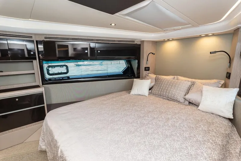 Rogue 33 Yacht Photos Pics Luxurious bedroom interior of 2019 Azimut Atlantis 51 yacht with elegant bedding and modern lighting.