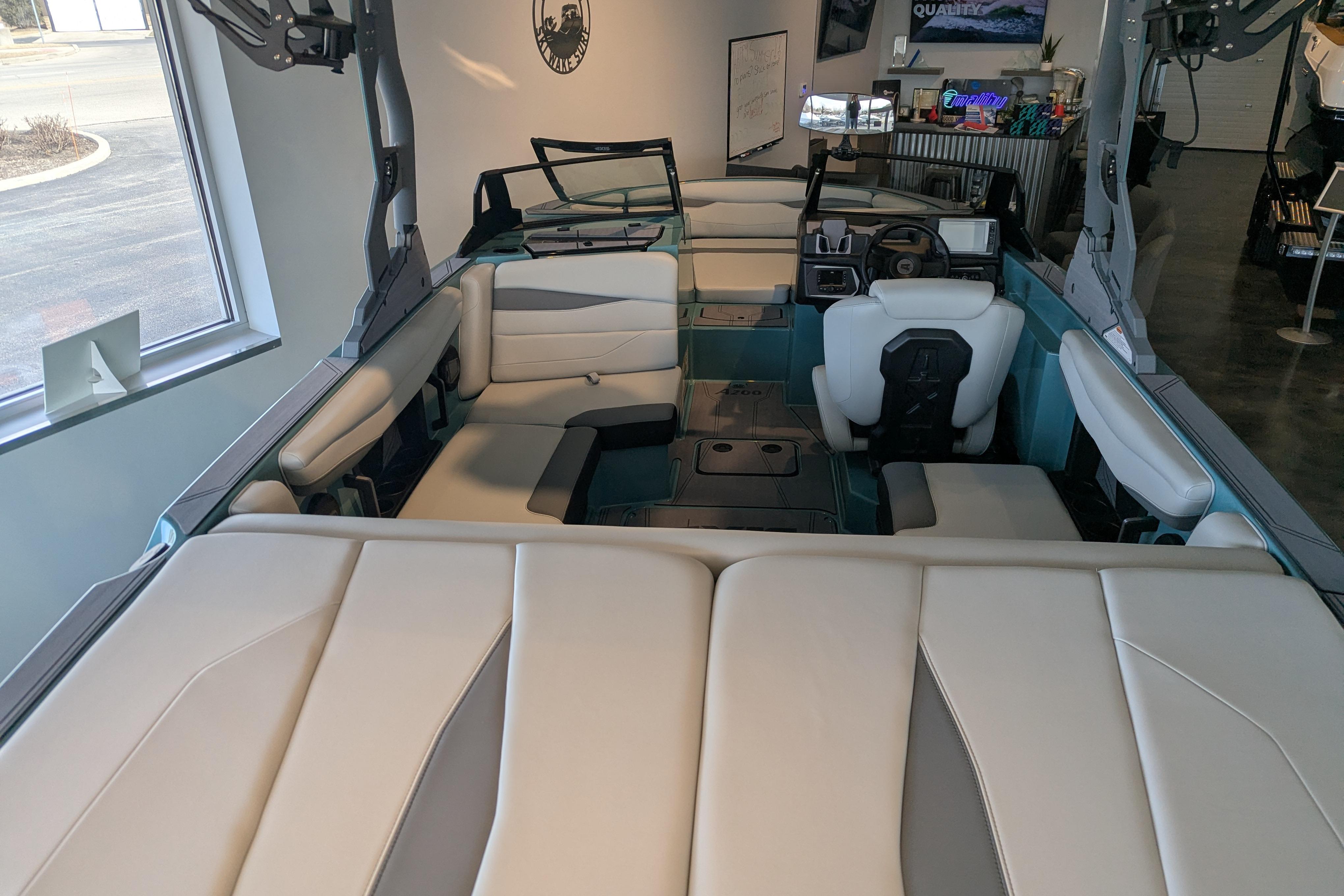 2026 Axis A200 boat interior with modern seating and dashboard in showroom.
