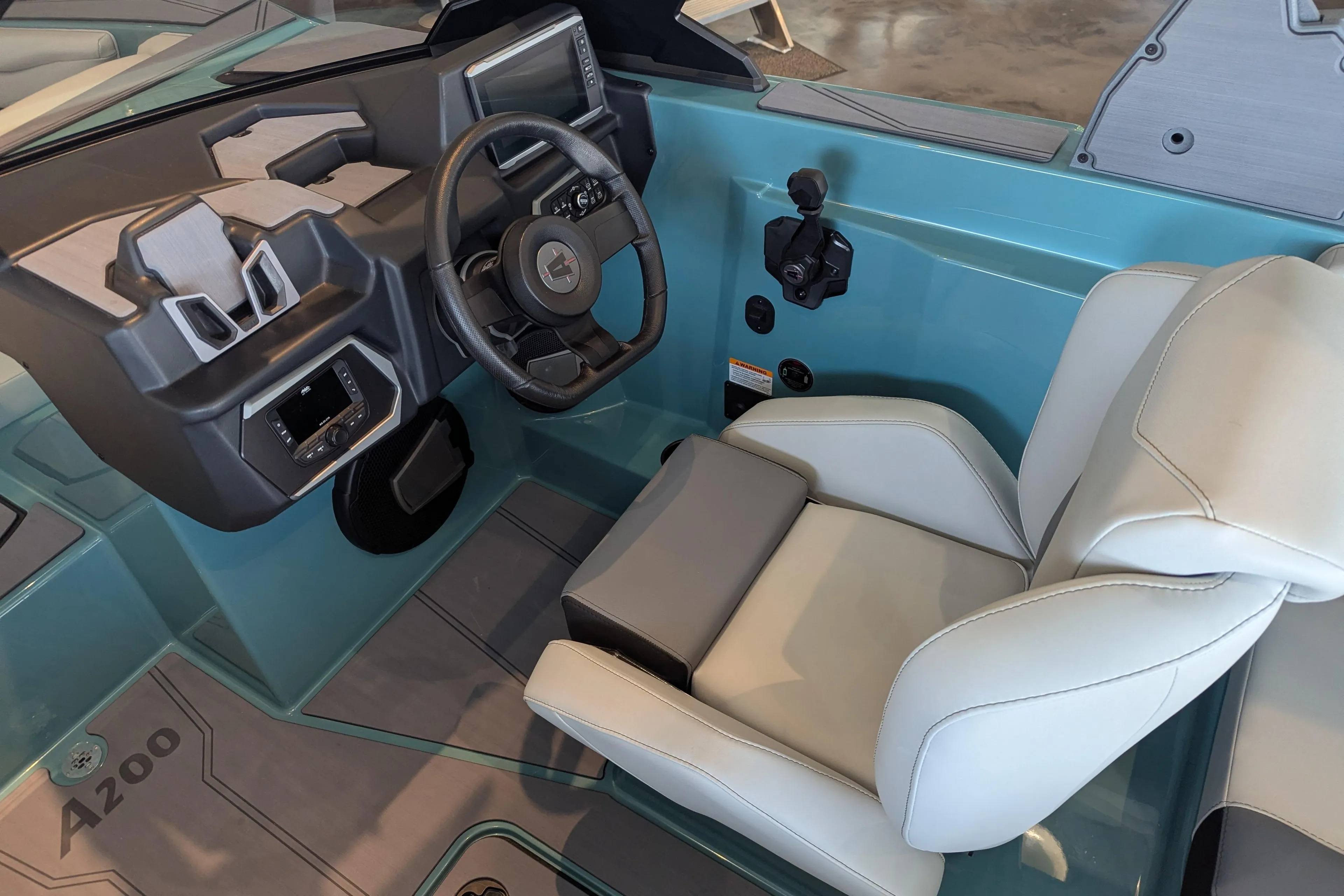 Interior of 2026 Axis A200 boat featuring modern steering and comfortable seating.