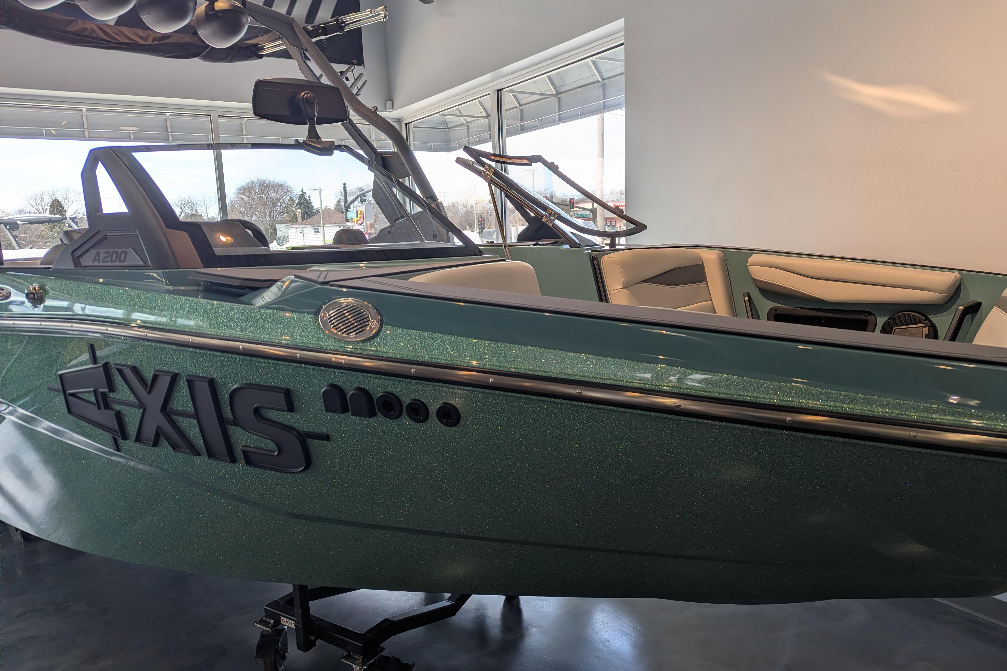 2026 Axis A200 boat in showroom, green exterior, sleek design.