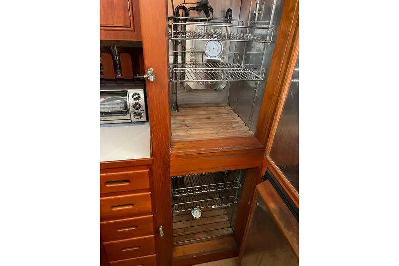 Daddy's Dream Yacht Photos Pics Interior of 1991 Grand Banks 46 Motoryacht showing wooden cabinetry and storage shelves.