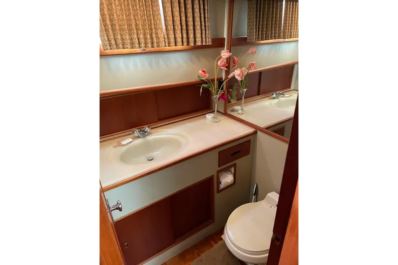 Daddy's Dream Yacht Photos Pics Bathroom interior of 1991 Grand Banks 46 Motoryacht with sink, toilet, and floral decor.