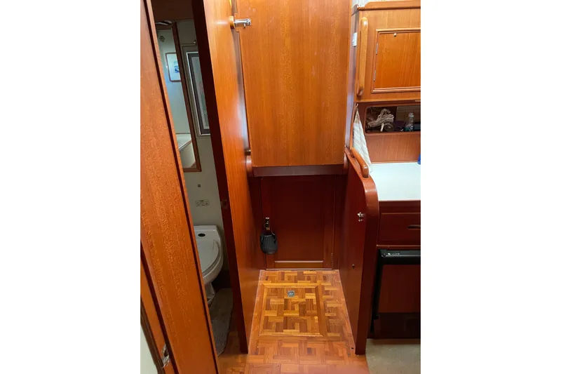 Daddy's Dream Yacht Photos Pics Interior of 1991 Grand Banks 46 Motoryacht with wooden cabinetry and parquet flooring.