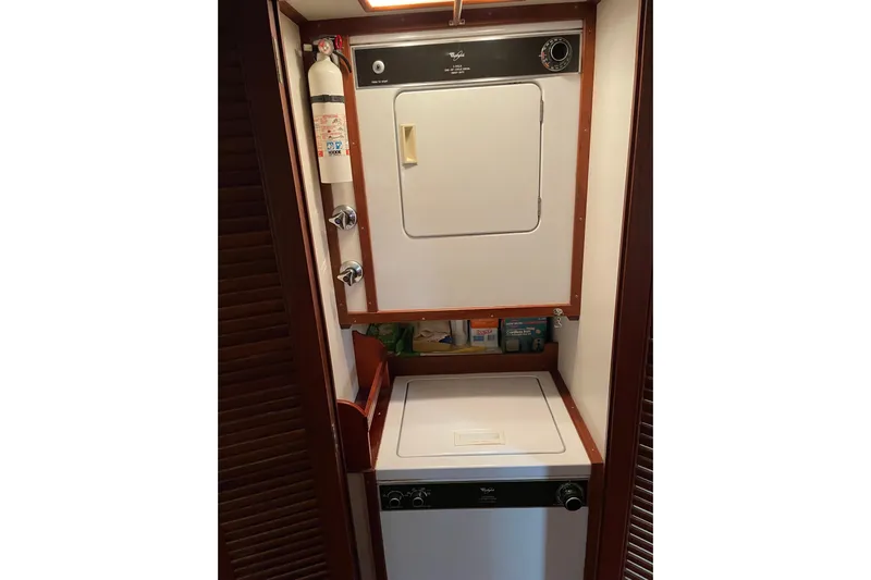 Daddy's Dream Yacht Photos Pics Laundry area in 1991 Grand Banks 46 Motoryacht with washer, dryer, and fire extinguisher.