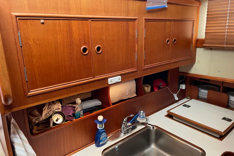Daddy's Dream Yacht Photos Pics Interior of 1991 Grand Banks 46 Motoryacht kitchen with wooden cabinets and sink.