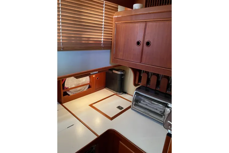 Daddy's Dream Yacht Photos Pics Galley of 1991 Grand Banks 46 Motoryacht with wooden cabinets and modern appliances.
