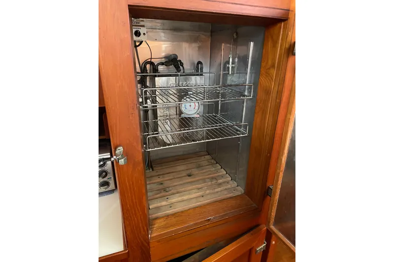 Daddy's Dream Yacht Photos Pics Empty wooden cabinet with metal shelves in a 1991 Grand Banks 46 Motoryacht.