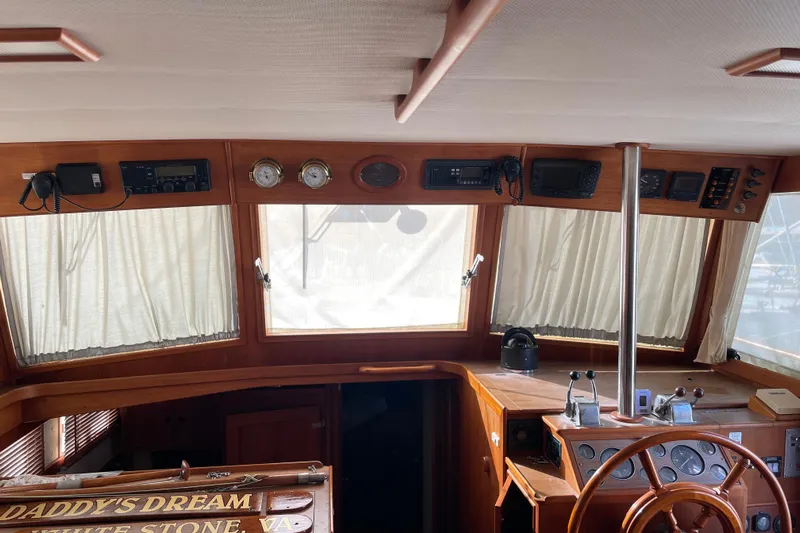 Daddy's Dream Yacht Photos Pics Interior helm of 1991 Grand Banks 46 Motoryacht with wooden steering wheel and navigation instruments.
