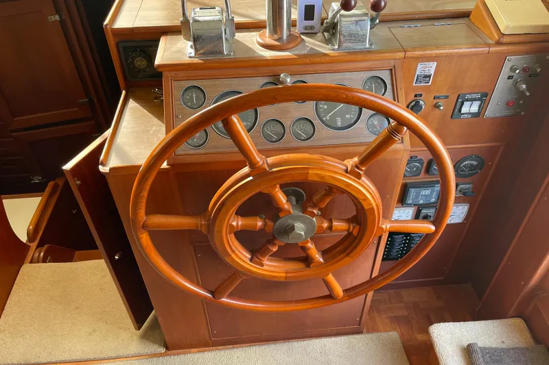 Daddy's Dream Yacht Photos Pics Wooden helm of a 1991 Grand Banks 46 Motoryacht with classic nautical instruments.