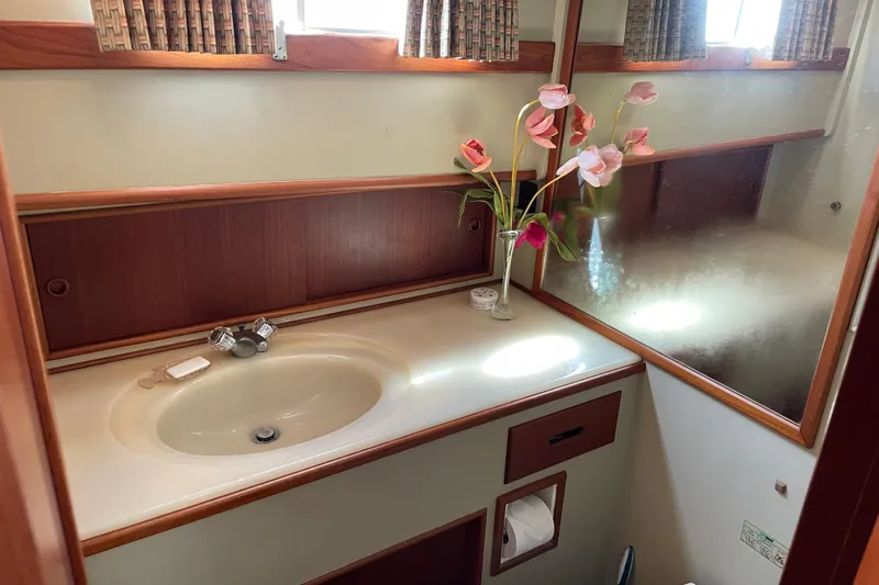 Daddy's Dream Yacht Photos Pics Bathroom interior of 1991 Grand Banks 46 Motoryacht with sink and floral decor.