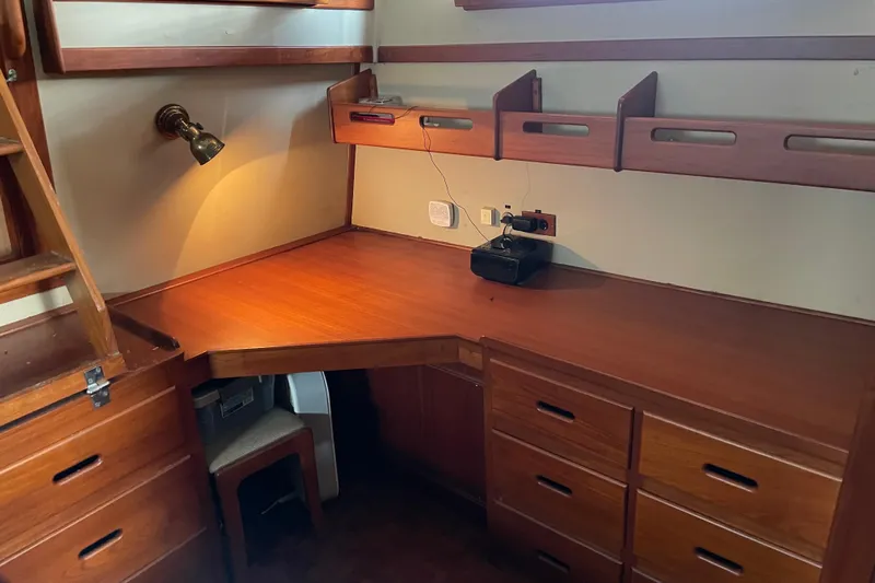 Daddy's Dream Yacht Photos Pics Wooden desk area in 1991 Grand Banks 46 Motoryacht, featuring drawers and shelves.