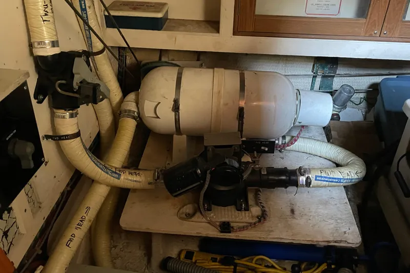 Daddy's Dream Yacht Photos Pics Engine room of 1991 Grand Banks 46 Motoryacht with plumbing and equipment.