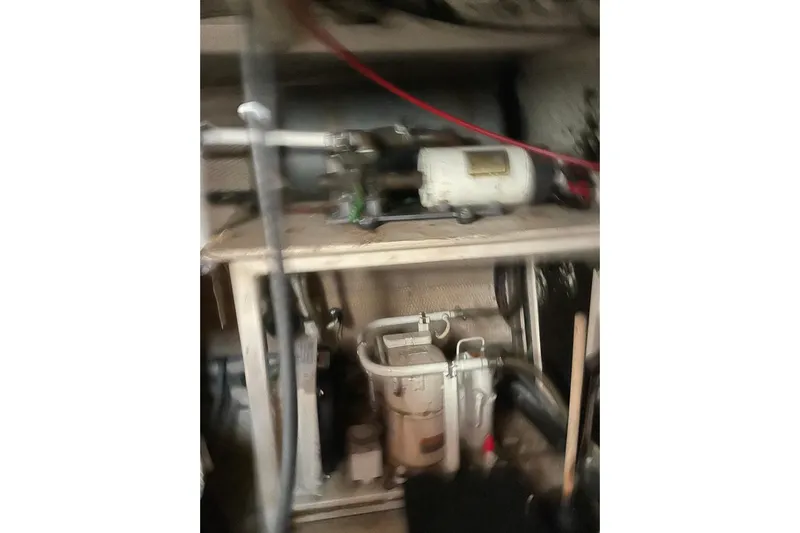 Daddy's Dream Yacht Photos Pics Engine room of 1991 Grand Banks 46 Motoryacht, featuring mechanical equipment and piping.