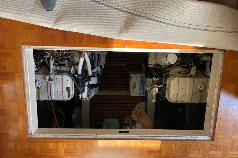 Daddy's Dream Yacht Photos Pics Engine room of 1991 Grand Banks 46 Motoryacht with visible machinery and parquet flooring.