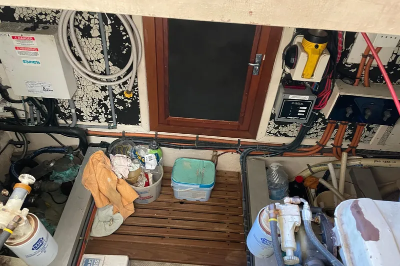 Daddy's Dream Yacht Photos Pics Engine room of 1991 Grand Banks 46 Motoryacht with equipment and storage items.