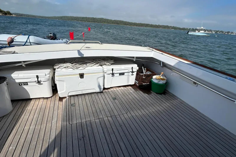 Nellie Yacht Photos Pics 1995 Holland Pettegrow Cruiser deck with coolers, docked on a scenic lake.