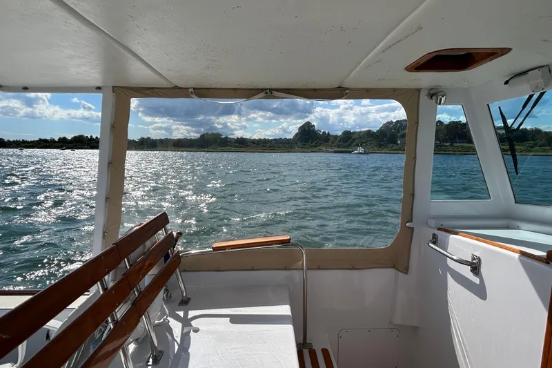 Nellie Yacht Photos Pics 1995 Holland Pettegrow Cruiser interior with scenic water view through windows.