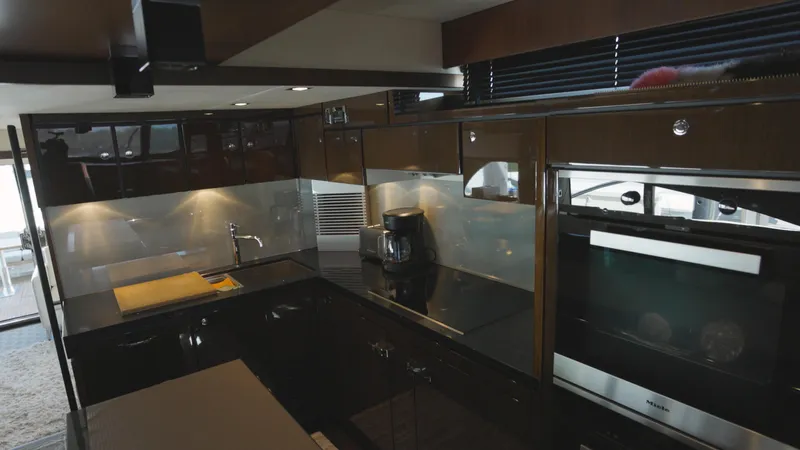  Yacht Photos Pics Luxurious kitchen interior of 2014 Fairline Squadron 78 Custom yacht, featuring modern appliances.