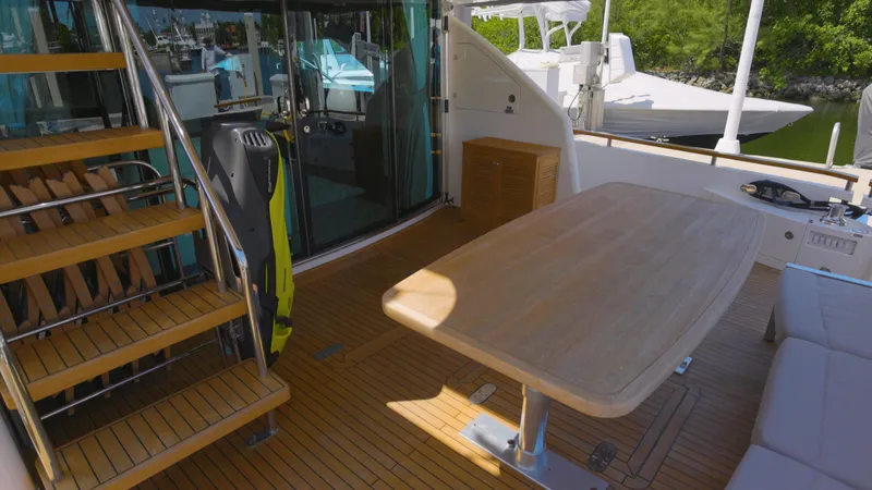  Yacht Photos Pics 2014 Fairline Squadron 78 Custom yacht deck with wooden table and stairs.