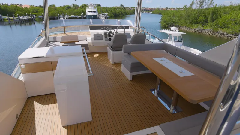  Yacht Photos Pics 2014 Fairline Squadron 78 Custom yacht deck with seating and helm, overlooking serene waterway.