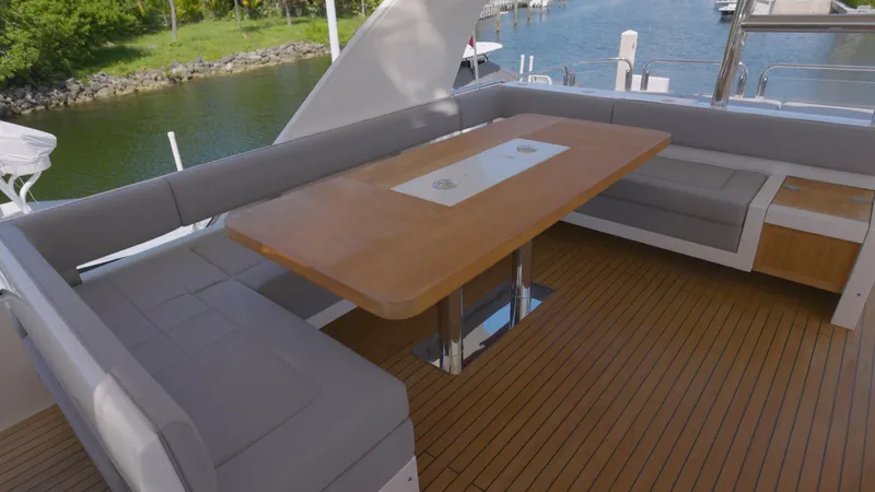  Yacht Photos Pics Luxurious seating area on 2014 Fairline Squadron 78 Custom yacht, featuring elegant wood table.