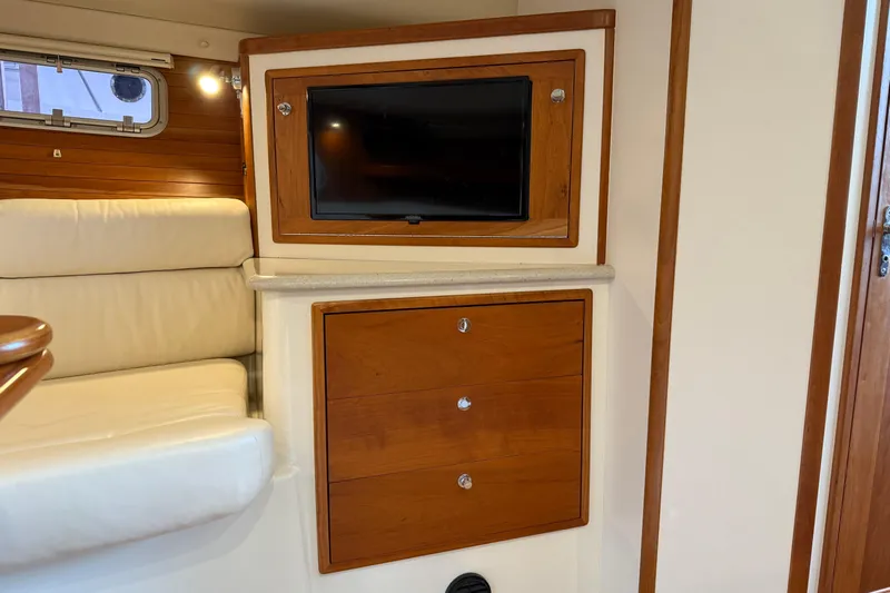 Kikiriki Yacht Photos Pics Interior of 2007 MJM 34z Downeast yacht with TV and wooden cabinetry.