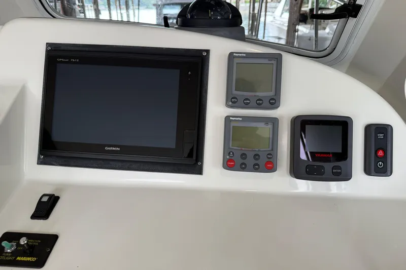 Kikiriki Yacht Photos Pics 2007 MJM 34z Downeast boat dashboard with Garmin and Raymarine displays.