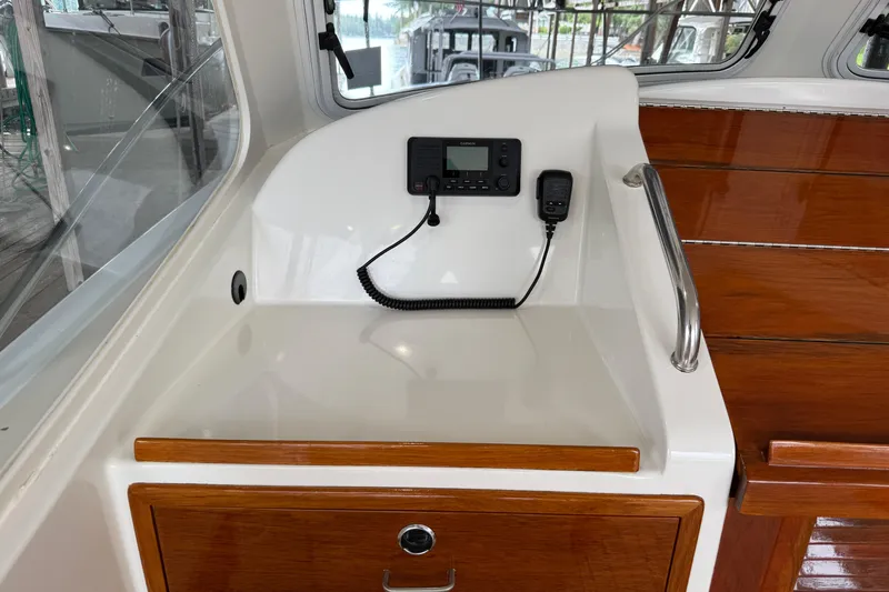 Kikiriki Yacht Photos Pics 2007 MJM 34z Downeast boat interior with radio and wooden cabinetry.