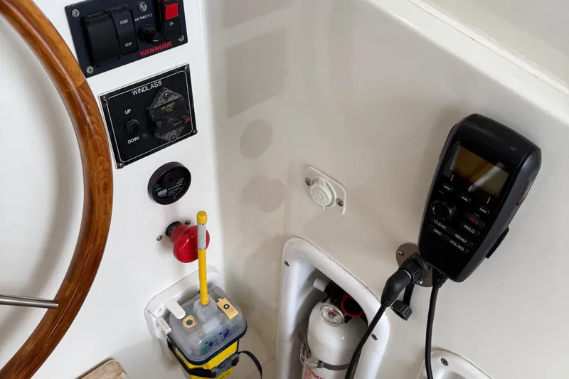 Kikiriki Yacht Photos Pics 2007 MJM 34z Downeast boat helm with controls, steering wheel, and communication device.