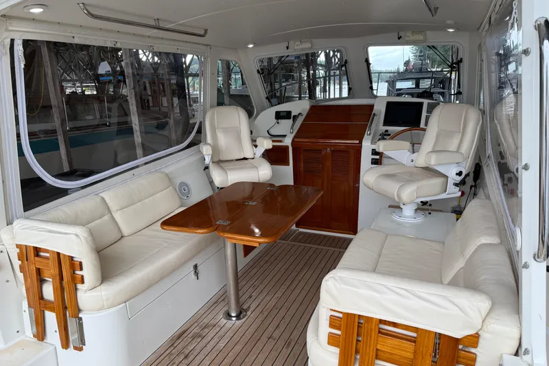 Kikiriki Yacht Photos Pics 2007 MJM 34z Downeast boat interior with leather seating and wooden table.